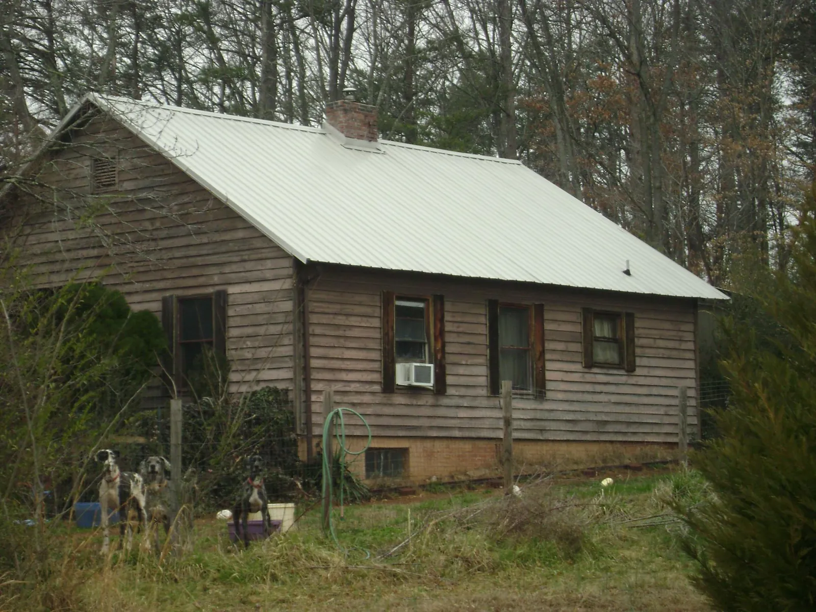 White metal roof on an old wood sided farmhouse, from a Asphalt Shingle Roof Repair job in Kent